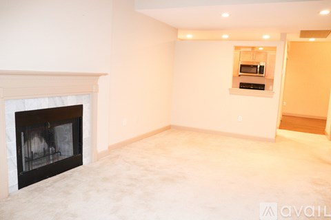 A living room with a fireplace and a television on the wall.
