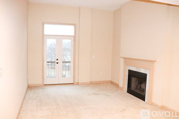 A room with a fireplace and a door with a window.