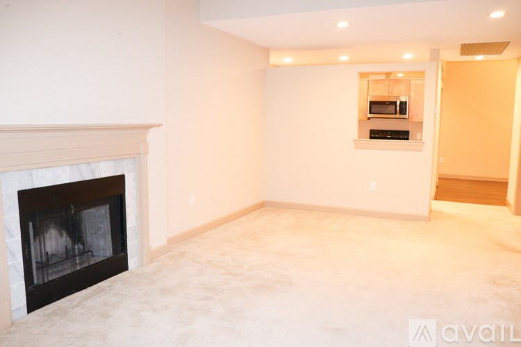 A living room with a fireplace and a television above it.