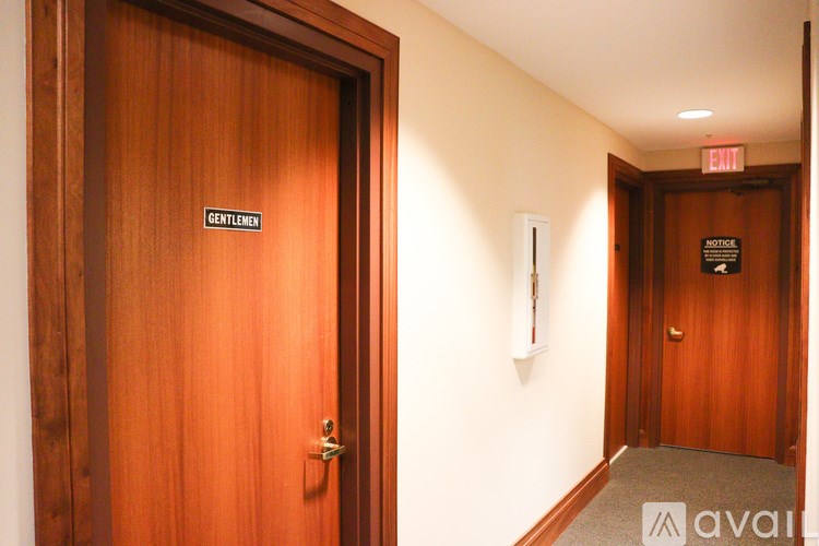 A wooden door with a sign that says "Gentlemen" on it.