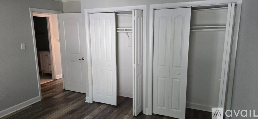 Three white doors are open in a room.