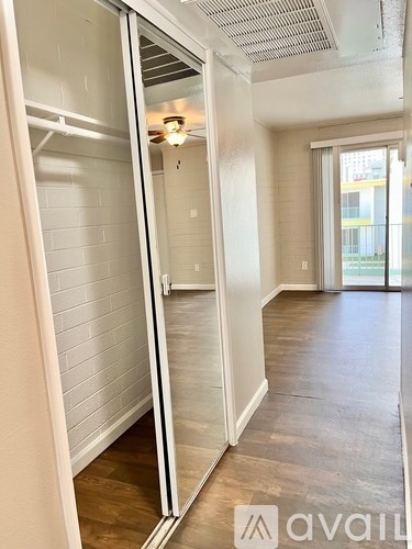 A room with a sliding door and a ceiling fan.