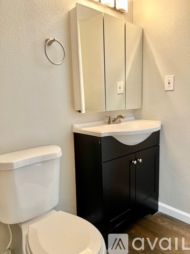 A white toilet sits next to a sink in a bathroom.