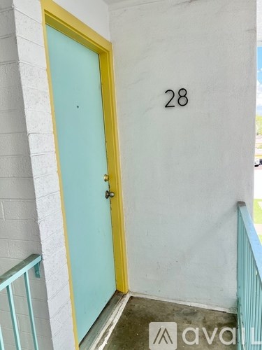 A yellow door with a number 28 on the wall.