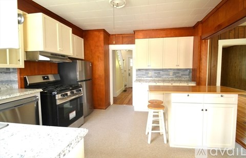 A kitchen with a stove top oven and a counter top.