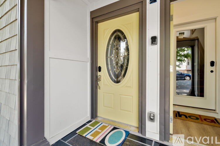 A white door with a glass window and a round design in the middle.