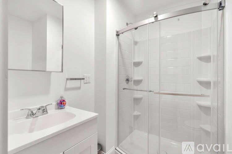 A white bathroom with a walk-in shower.