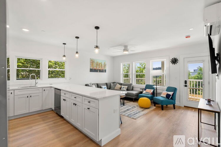A kitchen with white cabinets and a large island with a countertop.