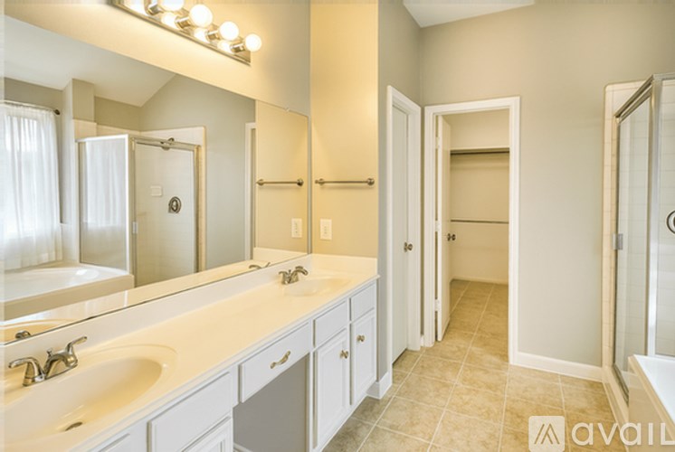 A bathroom with a sink, mirror, and cabinets.
