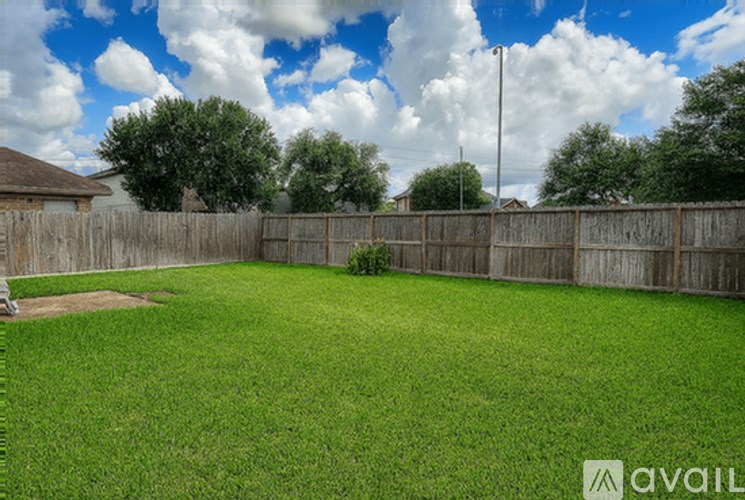 A backyard with a wooden fence and a baseball diamond.