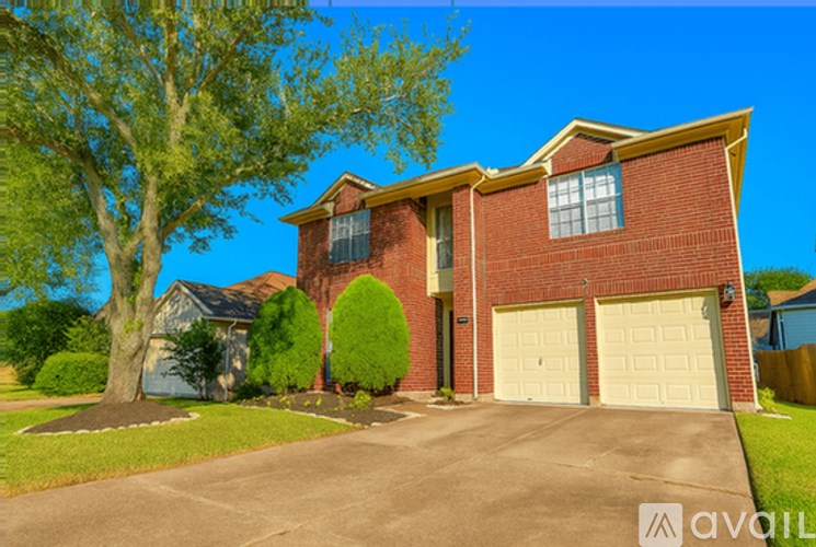 A house with a red brick exterior and a white garage door is for sale.