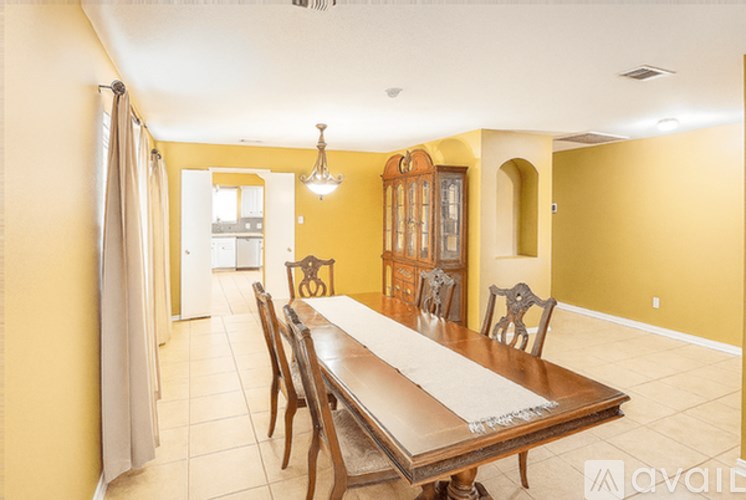 A dining room with a long table and chairs.