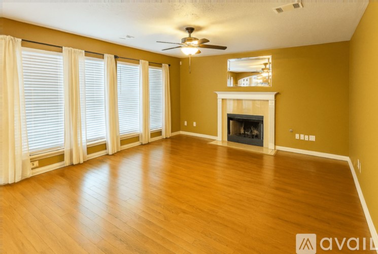 A spacious living room with a fireplace and sliding glass doors.