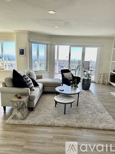 A living room with a large window overlooking the city.