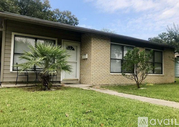 A house with a lawn in front of it.