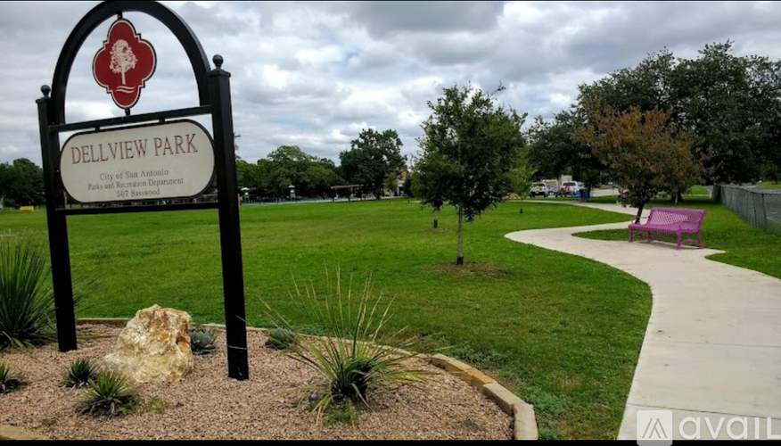 A sign for Dellview Park stands in a grassy area.