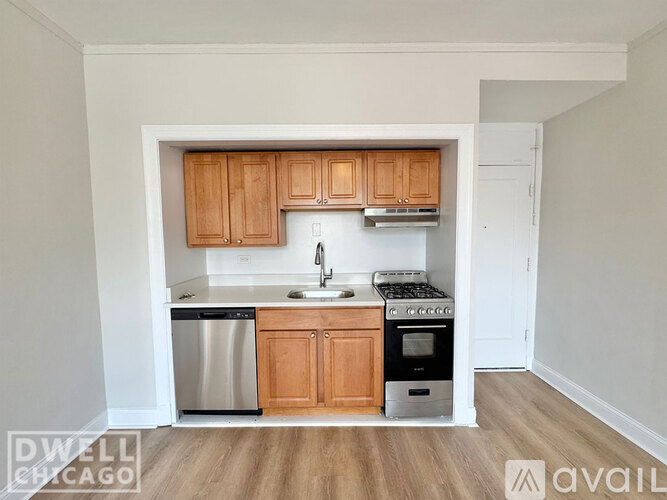 A kitchen with white appliances and wooden floors.