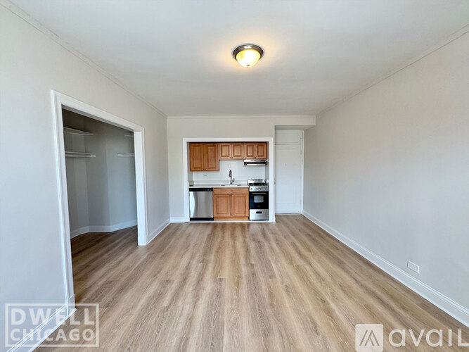 A kitchen with a white fridge, white stove and wooden cabinets.