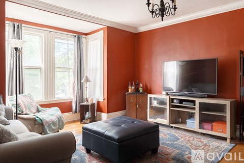 A living room with a television and a couch.