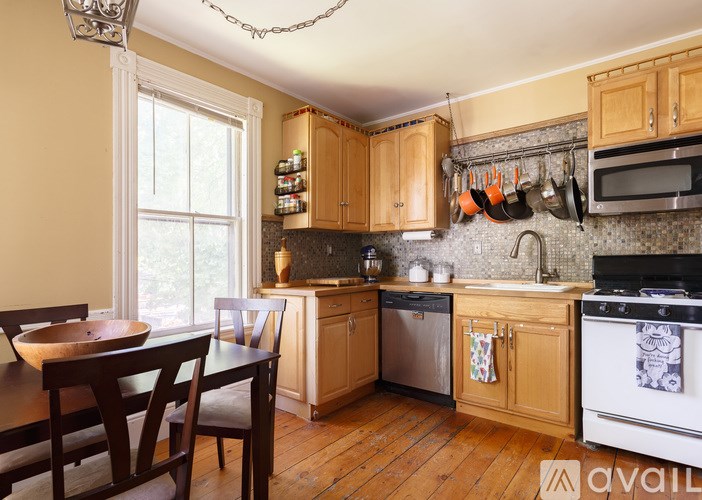 A kitchen with wooden cabinets and a dining table.