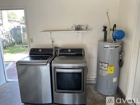 A stainless steel oven and microwave are on a counter in a kitchen.