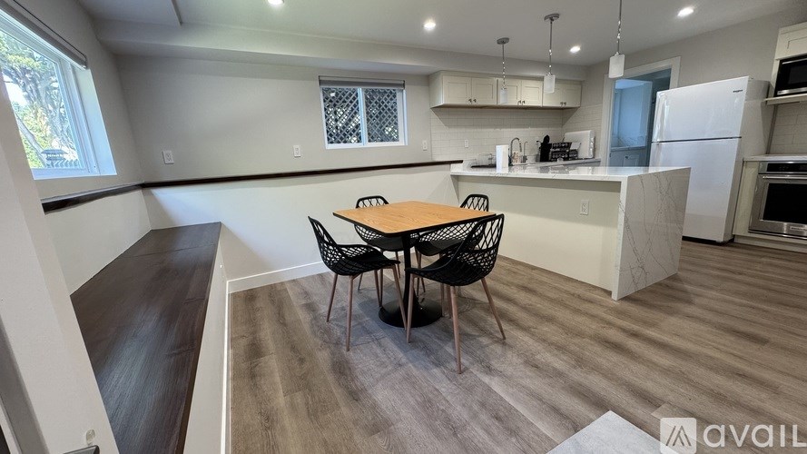 A kitchen with a table and chairs in the middle of the room.