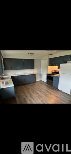 A kitchen with dark wood cabinets and a wooden table.