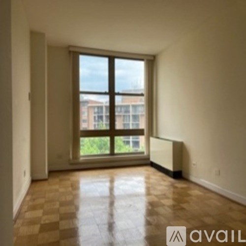 A room with a window and a radiator on the floor.