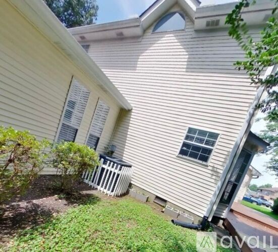 A house with a white picket fence and a window.