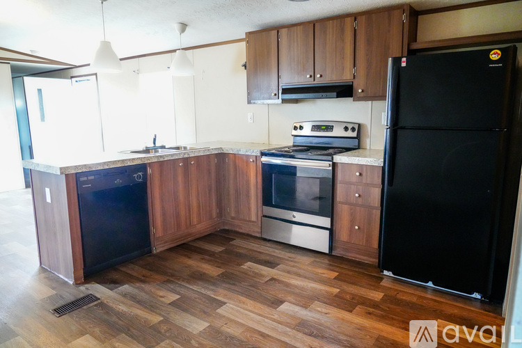 A room with wooden flooring and a television on a wooden cabinet.
