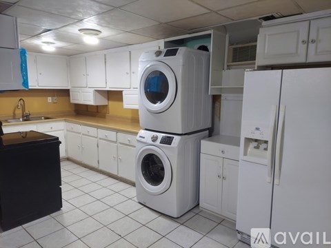 A white washing machine and refrigerator in a kitchen.