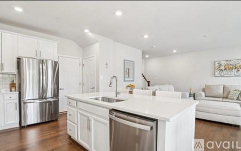A modern kitchen with white cabinets and a large island.
