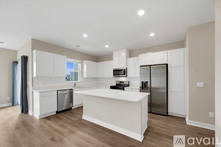 A kitchen with a white countertop and a stove top oven.