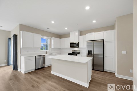 A kitchen with a white countertop and a stove top oven.