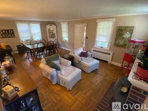A living room with a sofa set and a dining table.