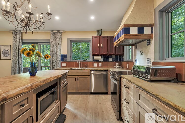 A kitchen with wooden cabinets and a granite countertop.