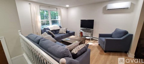 A living room with a grey couch and a television.
