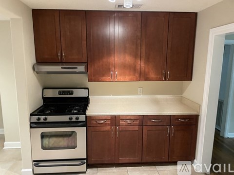 A kitchen with a stove and cabinets.
