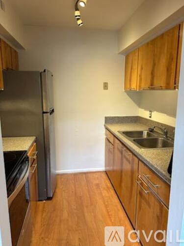 A kitchen with wooden cabinets and a granite countertop.