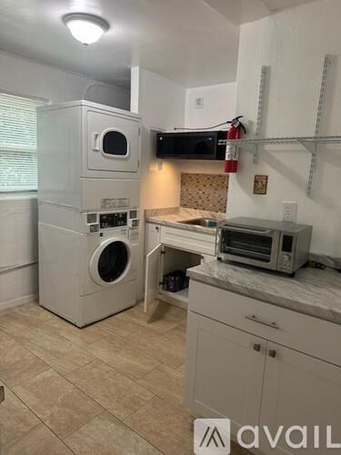 A kitchen with wooden cabinets and a granite countertop.