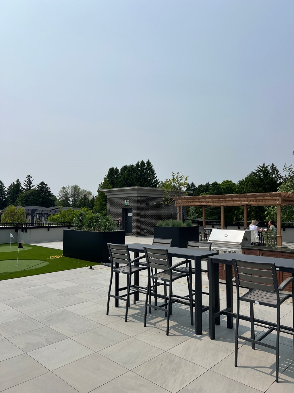 A patio with a table and chairs is set up on a sunny day.