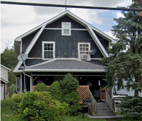 A house with a black front and white windows.