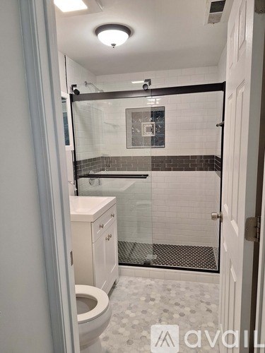 A bathroom with a toilet, sink, and bathtub.