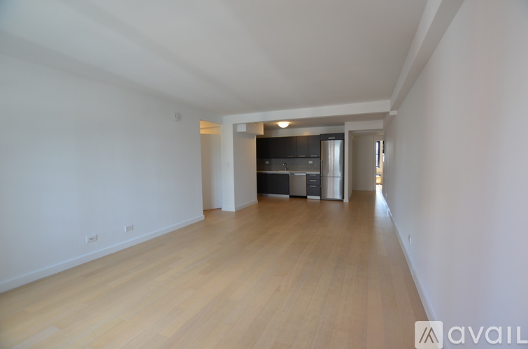 A long hallway with a kitchen at the end.