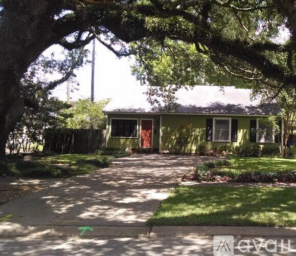 A house with a green lawn and a tree in front.
