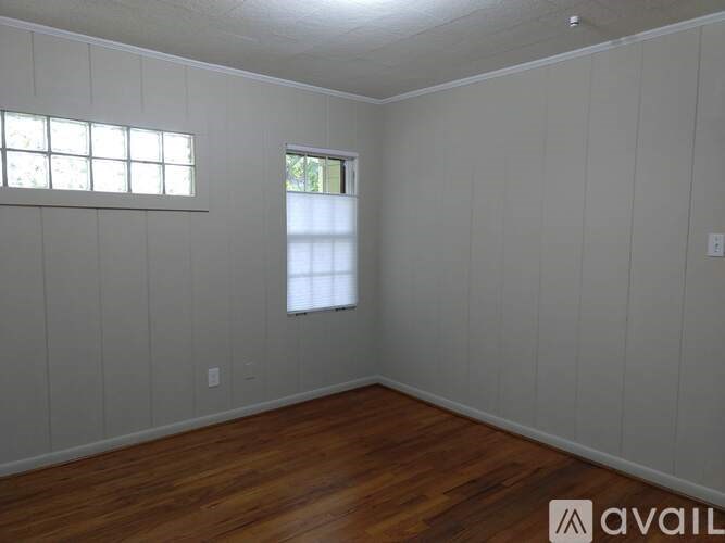 A room with wooden floors and white walls.
