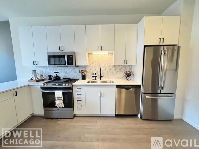 A kitchen with white cabinets and stainless steel appliances.