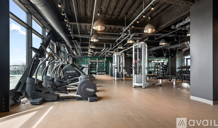 A gym with treadmills, weights, and exercise machines.