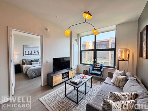 A living room with a grey couch and a black coffee table.