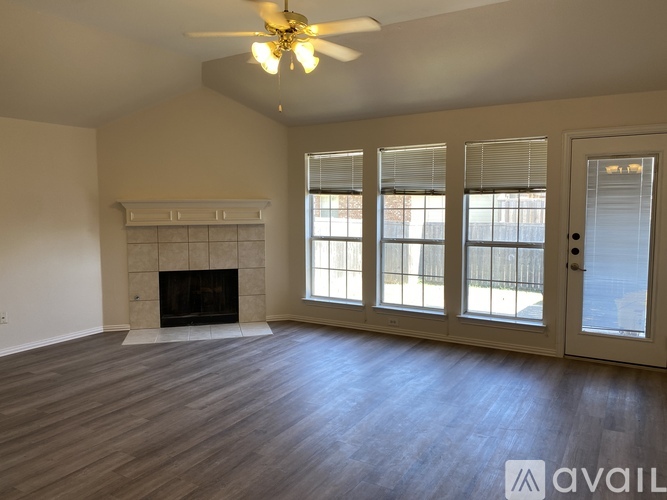 A spacious living room with a fireplace and sliding glass doors.